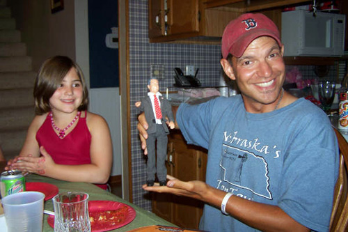 
                    BJ with a George Bush doll and Courtney, daughter of a friend.
                                            (Courtesy BJ Hill)
                                        